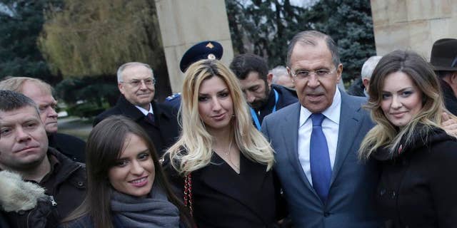FILE - In this Monday Dec. 12, 2016 file photo, Russian Foreign Minister Sergey Lavrov, second right, poses for photos with members of a far-right pro-Russian group of which Nemanja Ristic, first left, is a member. A Serbian court on Thursday Feb. 9, 2017, has rejected an extradition request by Montenegro for Nemanja Ristic suspected of taking part in an alleged pro-Russian plot to overthrow the small Balkan country's government. (AP Photo, File)