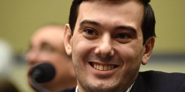 FILE - In this Feb. 4, 2016 file photo, Pharmaceutical chief Martin Shkreli smiles on Capitol Hill in Washington during the House Committee on Oversight and Reform Committee hearing on his former company's decision to raise the price of a lifesaving medicine. Shkreli announced on Twitter Sept. 26, 2016, that he would offer up a chance to punch him in the face as part of a fundraiser for the son of his former PR consultant, who recently died. (AP Photo/Susan Walsh, File)