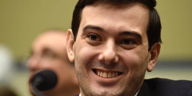 FILE - In this Feb. 4, 2016 file photo, Pharmaceutical chief Martin Shkreli smiles on Capitol Hill in Washington during the House Committee on Oversight and Reform Committee hearing on his former company's decision to raise the price of a lifesaving medicine. Shkreli announced on Twitter Sept. 26, 2016, that he would offer up a chance to punch him in the face as part of a fundraiser for the son of his former PR consultant, who recently died. (AP Photo/Susan Walsh, File)