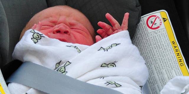 File picture taken on July 23, 2013 Prince William and Catherine, Duchess of Cambridge' new-born baby boy later named Prince George seen in a car seat outside the Lindo Wing of St Mary's Hospital in London.