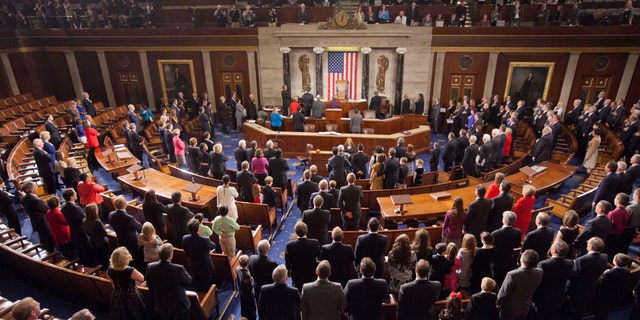 FILE --  Jan. 6, 2015: Members of the House of Representatives stand for the Pledge of Allegiance at the opening session of the 114th Congress, on Capitol Hill in Washington.