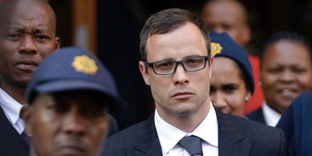 Oscar Pistorius, center, leaves the high court in Pretoria, South Africa, Thursday, Aug. 7, 2014. The chief prosecutor said Thursday the double-amputee athlete's lawyers have floated more than one theory in a dishonest attempt to defend against a murder charge for his killing of girlfriend Reeva Steenkamp. (AP Photo/Themba Hadebe)