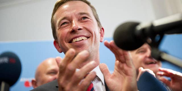 The head of the Alternative fuer Deutschland , AfD, party, Bernd Lucke, celebrates after the first exit polls for the Saxony State election , in Berlin, Sunday Aug. 31, 2014. Exit polls say the party that wants Germany to ditch the euro currency will be elected to a state assembly for the first time. The polls indicate that the party, Alternative for Germany, won 10 percent of the vote in Sunday's elections for the Saxony state parliament. (AP Photo/dpa, Daniel Naupold)