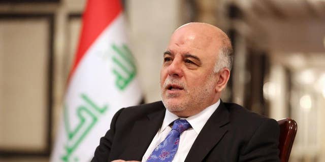 Iraq's Prime Minister Haider al-Abadi speaks during an interview with The Associated Press in Baghdad, Iraq, Wednesday, Sept. 17, 2014. Iraq’s new prime minister says foreign ground troops are neither necessary nor wanted in his country’s fight against the Islamic State group. (AP Photo/Hadi Mizban)