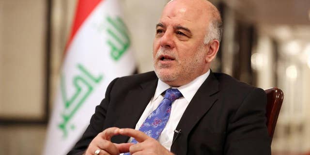 Iraq's Prime Minister Haider al-Abadi speaks during an interview with The Associated Press in Baghdad, Iraq, Wednesday, Sept. 17, 2014. Iraq’s new prime minister says foreign ground troops are neither necessary nor wanted in his country’s fight against the Islamic State group. (AP Photo/Hadi Mizban)