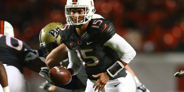 Miami quarterback Brad Kaaya runs plays against Pittsburgh during the first half of an NCAA college football game in Miami Gardens, Fla., Saturday, Nov. 29, 2014. (AP Photo/J Pat Carter)