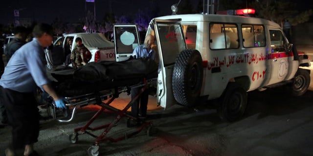 Medic personnel transport the body of a victim into an ambulance at the site of a suicide attack on a Shiites mosque in Kabul, Afghanistan, Thursday, June 15, 2017. A suicide bomber struck outside a Shiite mosque in the Afghan capital Kabul late Thursday night, killing a leader of Afghanistan's ethnic Hazaras, Hajji Ramazan Hussainzada, and others. (AP Photos/Massoud Hossaini)