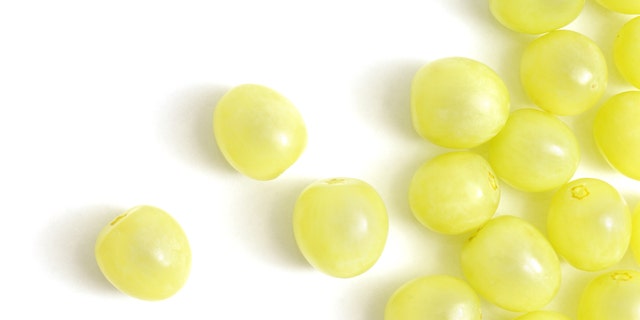 The boy's mother was looking at cheese and did not know he had gotten into the grapes.