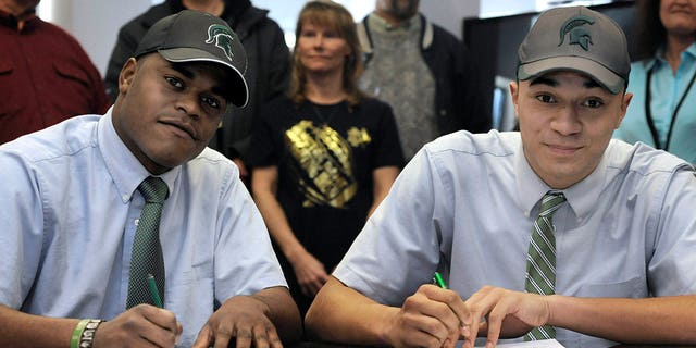Cathedral Preparatory School seniors Delton Williams, left, and Damion Terry, attend a ceremonial letter-of-intent signing at the school in Erie, Pa., on Wednesday, Feb. 6, 2013. Earlier in the day, they signed their actual letters of intent to attend and play football at Michigan State. (AP Photo/Erie Times-News, Christopher Millette) MAGS OUT, TV OUT