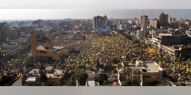 Tens of thousands of Palestinians marched Friday carrying yellow banners of Palestinian President Mahmoud Abbas' Fatah party during celebrations marking the 48th anniversary of the Fatah movement in Gaza City, Friday, Jan. 4, 2013. Fatah is staging its first rally in the Islamist Hamas-controlled Gaza Strip since 2007, reflecting warming ties between the two rival factions. (AP Photo/Adel Hana)