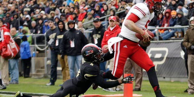 Wisconsin quarterback Tanner McEvoy, left, scores a touchdown in front of Purdue safety Taylor Richards (4) during the second half of an NCAA college football game in West Lafayette, Ind., Saturday, Nov. 8, 2014. Wisconsin won 34-16. (AP Photo/AJ Mast)