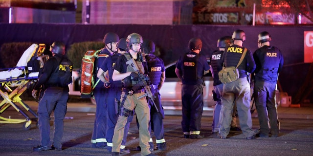 Police officers stand at the scene of a shooting near the Mandalay Bay resort and casino on the Las Vegas Strip, Monday, Oct. 2, 2017, in Las Vegas.