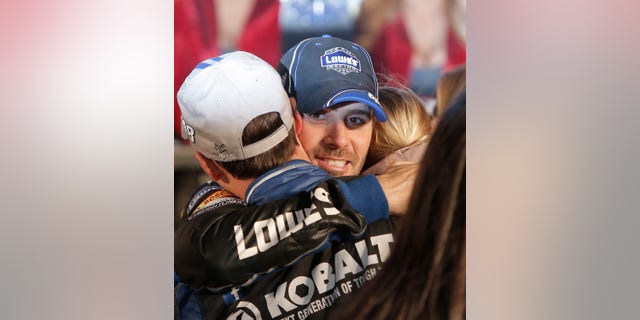 Jimmie Johnson hugs his crew in victory lane after winning the NASCAR Sprint Cup series auto race at Texas Motor Speedway in Fort Worth, Texas, Sunday, Nov. 3, 2013. (AP Photo/Brandon Wade)