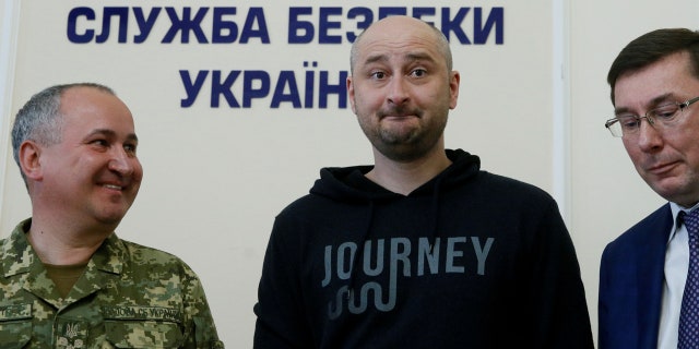 Russian journalist Arkady Babchenko (C), who was reported murdered in the Ukrainian capital on May 29, Ukrainian Prosecutor General Yuriy Lutsenko (R) and head of the state security service (SBU) Vasily Gritsak attend a news briefing in Kiev, Ukraine May 30, 2018.