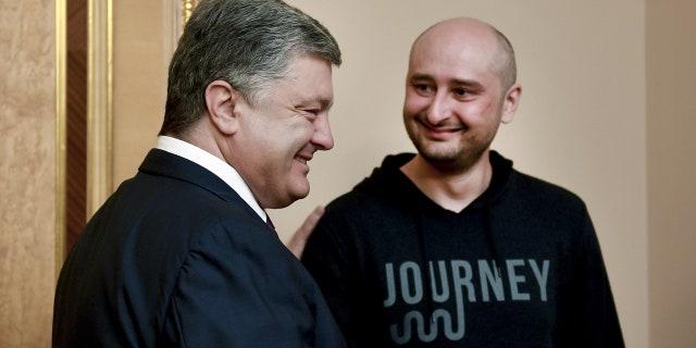Ukrainian President Petro Poroshenko meets with Russian journalist Arkady Babchenko, who was declared murdered and then later turned up alive, in Kiev, Ukraine May 30, 2018.