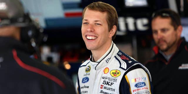 Driver Brad Keselowski talks with his crew during practice for Sunday's NASCAR Sprint Cup Series auto race at New Hampshire Motor Speedway Friday Sept. 19, 2014 in Loudon, N.H. (AP Photo/Jim Cole)