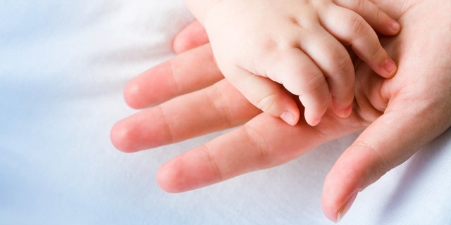 baby hand in moms hand istock medium