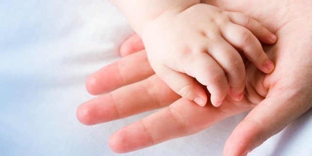 baby hand in moms hand istock medium