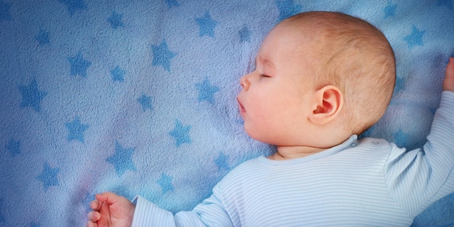 A 3-month-old baby sleeps on a blue blanket with stars. A New York City pediatrician on Saturday, May 14, 2022, shared tips for moms and dads amid the baby formula shortage.