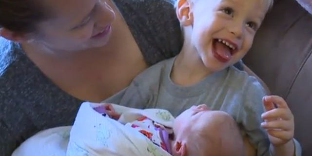 Baby Ella, pictured with her mother and older brother, was born in the family's car outside of the hospital's emergency room.
