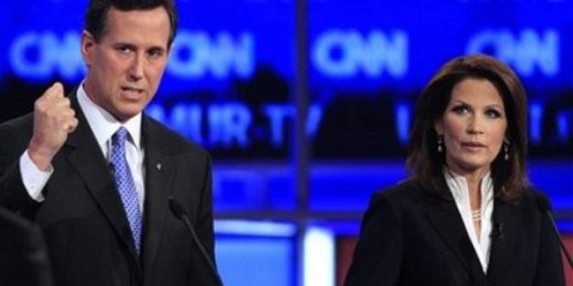 Former Pennsylvania Sen. Rick Santorum answers a question from CNN's John King, left, as Rep. Michele Bachmann, R-Minn., right, listens during the first New Hampshire Republican presidential debate at St. Anselm College in Manchester, N.H., Monday, June 13, 2011. (AP Photo/Jim Cole)