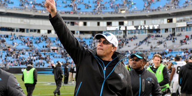 Carolina Panthers coach Ron Rivera acknowledges fans as he walks off the field after the Panthers defeated the Oakland Raiders 17-6 in an NFL football game in Charlotte, N.C., Sunday, Dec. 23, 2012. (AP Photo/Mike McCarn)