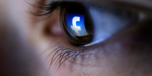 A picture illustration shows a Facebook logo reflected in a person's eye, in Zenica, March 13, 2015. (REUTERS/Dado Ruvic)