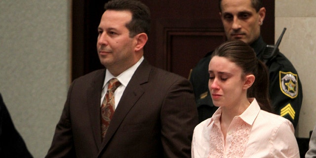 Casey Anthony holds hands with her defense attorney Jose Baez as they listen to the verdict at the Orange County Courthouse, July 5, 2011.