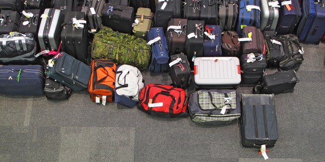 Dozens of suitcases in the airport floor