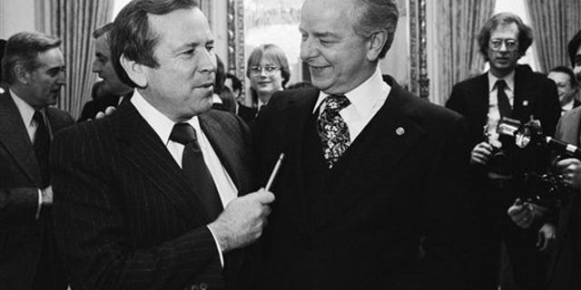 FILE - This Dec. 4, 1980 file photo shows Senate Majority Leader Robert Byrd of W.Va., right, talking to the man who will replace him, Sen. Howard Baker, R-Tenn., on Capitol Hill in Washington. Baker, who asked what President Richard Nixon knew about Watergate, has died. He was 88. (AP Photo/Chick Harrity, File)