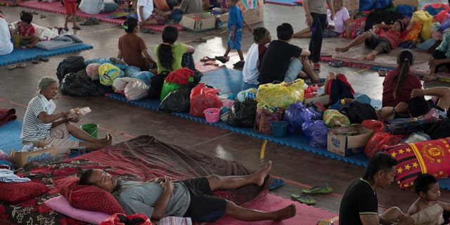 Villagers rest at a temporary evacuation center for people living near Mount Agung, a volcano on the highest alert level, inside a sports arena in Klungkung, on the resort island of Bali, Indonesia, Sept. 28, 2017.