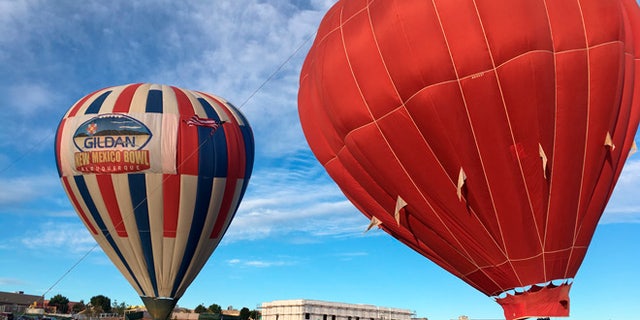 Two hot air balloons inflate at Vista Grande Elementary School in Rio Rancho, N.M. on Friday, Sept. 30, 2016.