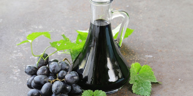balsamic vinegar in a glass jug with fresh grapes