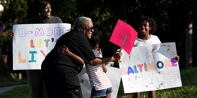 People attend the "Stop the Violence" rally at the intersection of Edmondson Avenue and Wildwood Parkway during the 72 hour community-led Baltimore Ceasefire against gun violence in Baltimore, Maryland, U.S. August 4, 2017. REUTERS/Sait Serkan Gurbuz - RTS1AGQQ