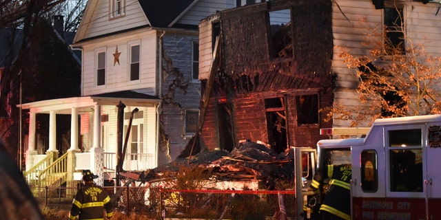 Baltimore City firefighters remain on the scene early Thursday, Jan. 12, 2017, after a fire on Springwood Avenue in northeast Baltimore. Several children and an adult were taken to an area hospital. Six children are still missing. (Jerry Jackson/The Baltimore Sun via AP)