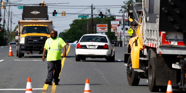 An emergency vehicle passes a roadblock near a scene where a Baltimore County police officer died, while investigating a suspicious vehicle, Monday, May 21, 2018, in Perry Hall, Md.