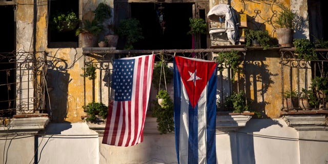 A U.S. and Cuban flag hang from the same balcony in Old Havana, Cuba, Friday, Dec. 19, 2014. After the surprise announcement on Wednesday of the restoration of diplomatic ties between Cuba and the U.S., many Cubans expressed hope that it will mean greater access to jobs and the comforts taken for granted elsewhere, and lift their struggling economy. However others feared a cultural onslaught, or that crime and drugs, both rare in Cuba, will become common along with visitors from the United States. (AP Photo/Ramon Espinosa)