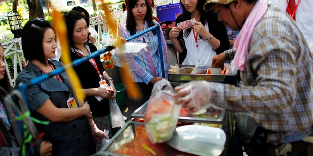 Street vendors hawk their wares in Bangkok, Thailand.