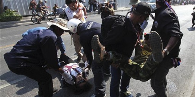Jan. 17, 2014: Injured anti-government protesters are taken out from a street by other protesters during a demonstration in Bangkok, Thailand.