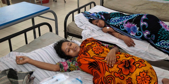 June 6, 2013: Bangladeshi garment workers who fell ill during their shifts at a sweater factory lie on beds at a hospital on the outskirts of Dhaka, Bangladesh. About 450 garment workers fell ill at the Starlight Sweater Factory near Bangladesh's capital, due to possible water contamination. A building collapse near Dhaka in April killed 1,129 workers, injured others and highlighted the hazardous working conditions in thousands of garment factories in Bangladesh.