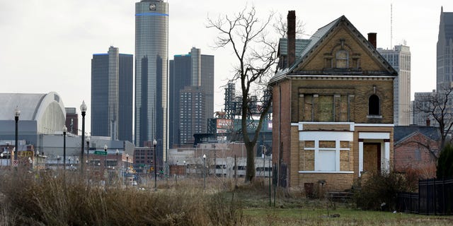 Dec. 2, 2013: An empty field in Brush Park, north of Detroit's downtown is shown with an abandoned home.