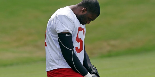 July 25, 2013: Atlanta Falcons linebacker Brian Banks (53) prays before working out at NFL football training camp in Flowery Branch, Ga. Banks is getting a chance with the Falcons after being sent to prison for a rape he didn't commit. (AP/John Bazemore)