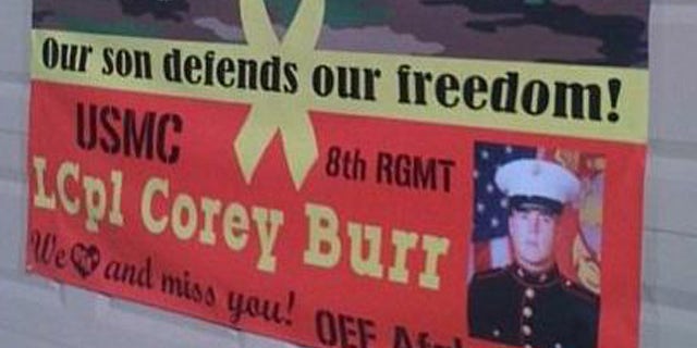 This photo, provided by Jodi Burr, shows the sign supporting their sign's military service. The Burr family says their homeowner's association is suing them for their refusal to take down the banner from their front yard.