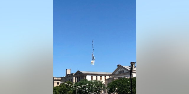 The banner was photographed floating down from the sky after breaking loose from its plane.