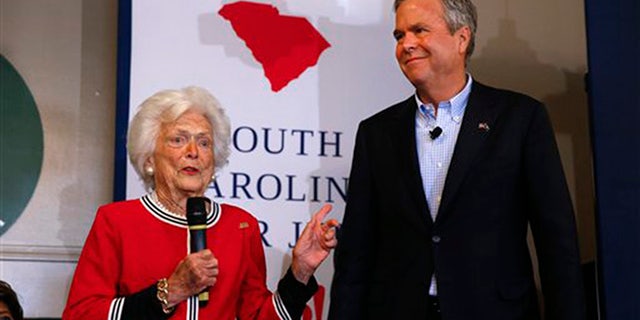 Republican presidential candidate, former Florida Gov. Jeb Bush, listens as his mother, former first lady Barbara speak during a campaign stop at Wade's Restaurant, Friday, Feb. 19, 2016 in Spartanburg, S.C. (AP Photo/Paul Sancya)