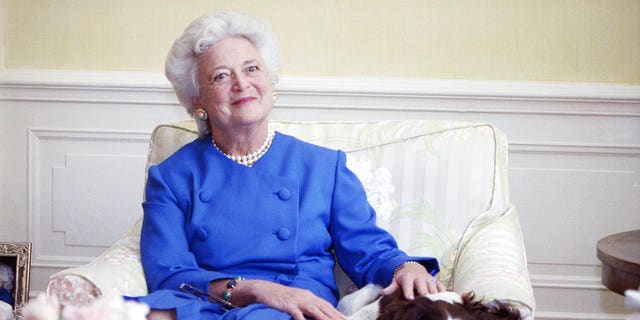 FILE - In this 1990 file photo, first lady Barbara Bush poses with her dog Millie in Washington. (AP Photo/Doug Mills, File)