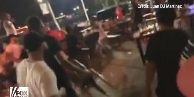Customers could be seen backing away as the brawlers reached for chairs to use as projectiles.