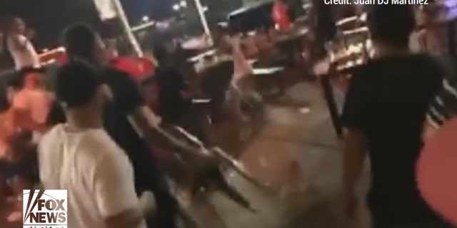 Customers could be seen backing away as the brawlers reached for chairs to use as projectiles.