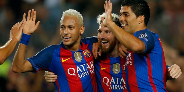 Barcelona's Lionel Messi, center, celebrates with his teammates Luis Suarez, right, and Neymar after scoring his side's fifth goal during a Champions League, Group C soccer match between Barcelona and Celtic, at the Camp Nou stadium in Barcelona, Spain, Tuesday, Sept. 13, 2016. (AP Photo/Manu Fernandez)