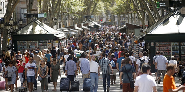 A man takes a selfie at Las Ramblas in Barcelona.